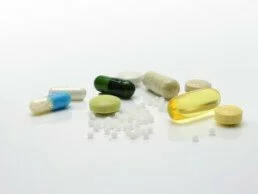 Pilules disposées devant fond blanc